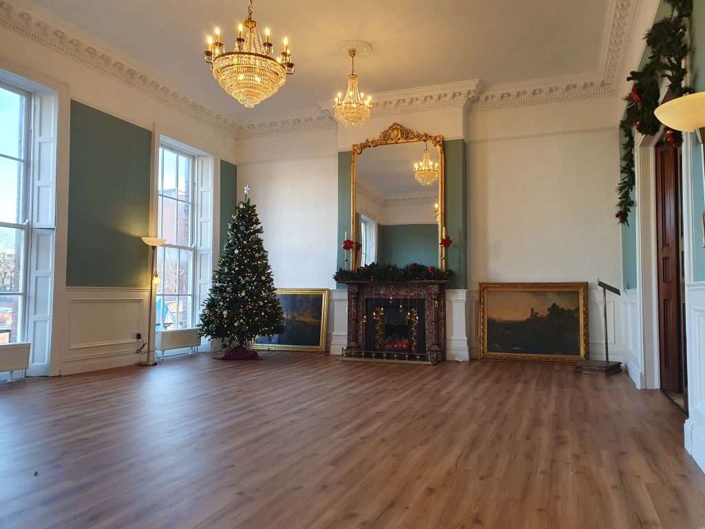 Room No. 42 at Christmas with Fireplace and Tree Room No. 42 decorated for Christmas, showing fireplace and Christmas tree, with no chairs set up