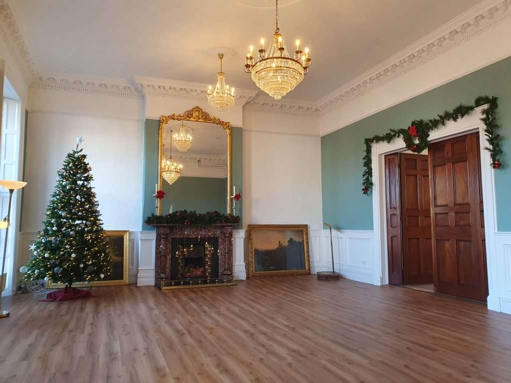 Rental Space No. 42 Decorated for Christmas, View from Back Left Near Georgian Windows Empty room decorated for Christmas, viewed from the back left side near large Georgian windows.