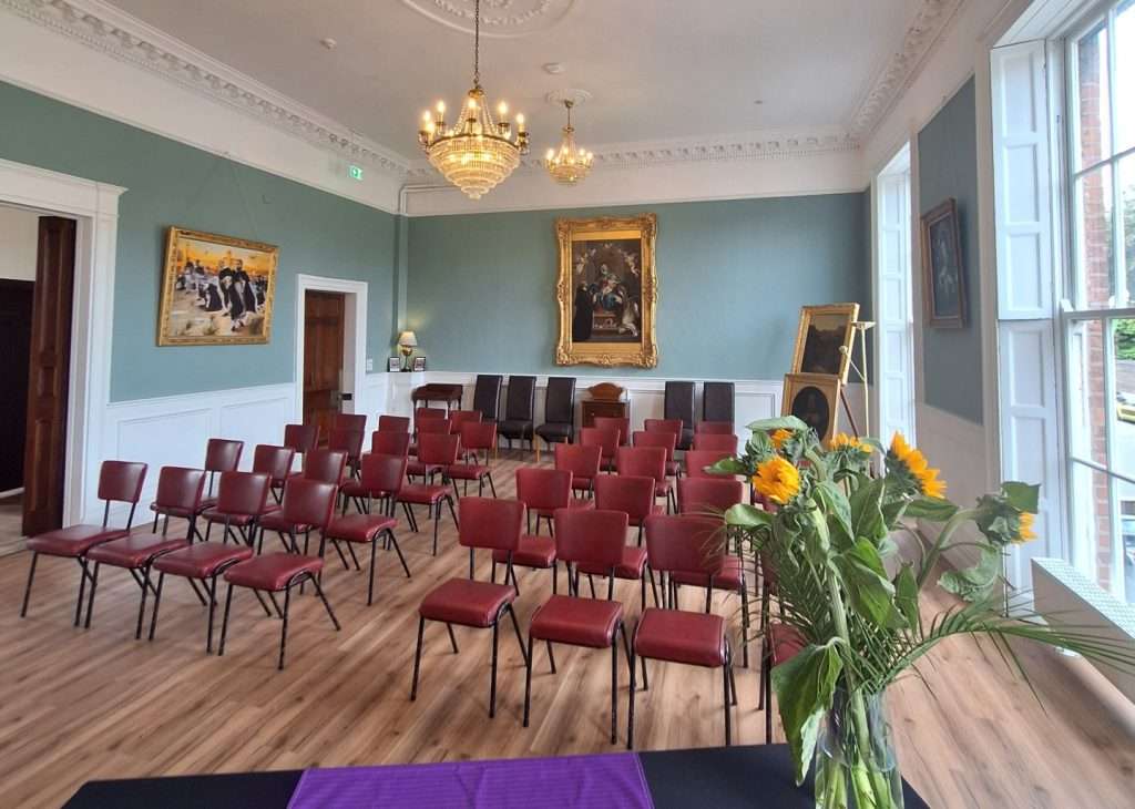 Rental Room No. 42 — Front Right View by Georgian Windows with Natural Light Rental Room No. 42 set up with chairs, viewed from front right near large Georgian windows with natural light