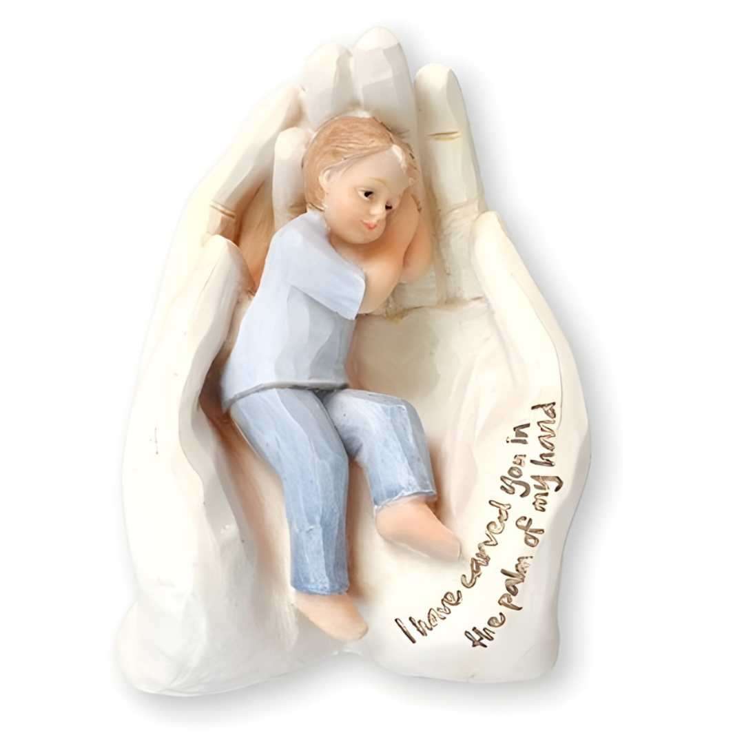 Resin statue of a young boy lying in the palm of God’s hand, 6½ inches, with inscription “I have carved you in the palm of my hand”